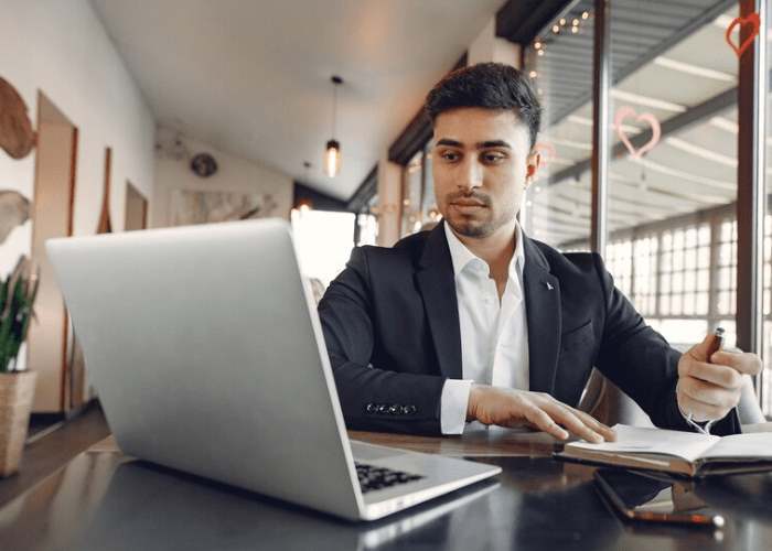 Business owner working on a laptop in an office supported by GRV IT Solutions